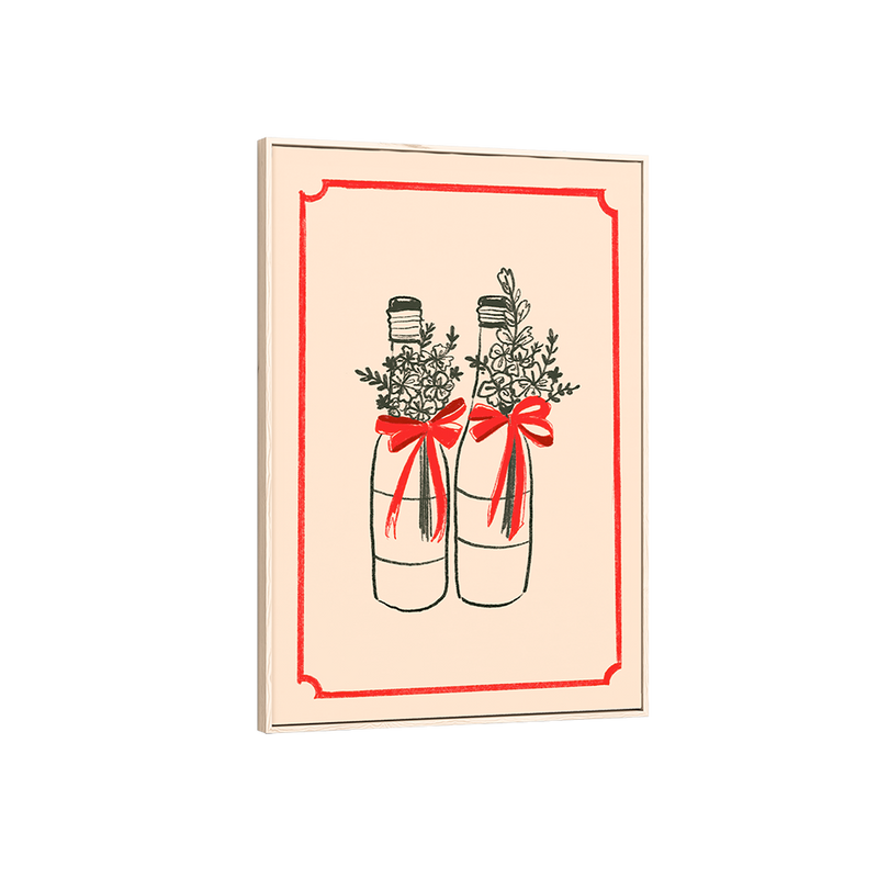 Framed artwork of two bottles with red bows and floral arrangements on a beige background