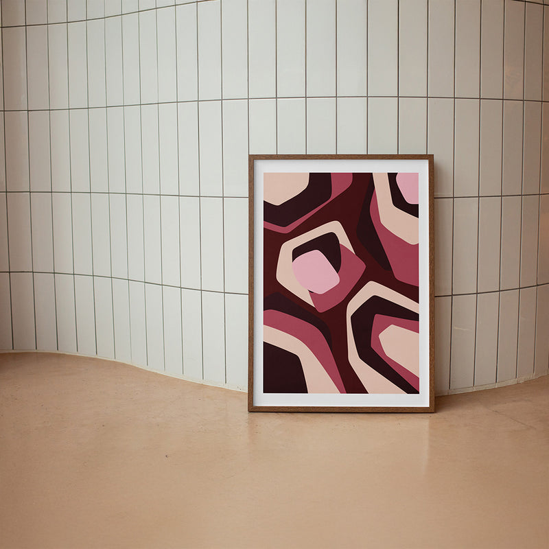 Framed abstract art print with geometric shapes in red and beige on a white background
